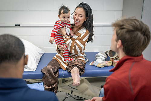 Kelly Yun with her son, is talking with students in the O&P clinic at Century College.